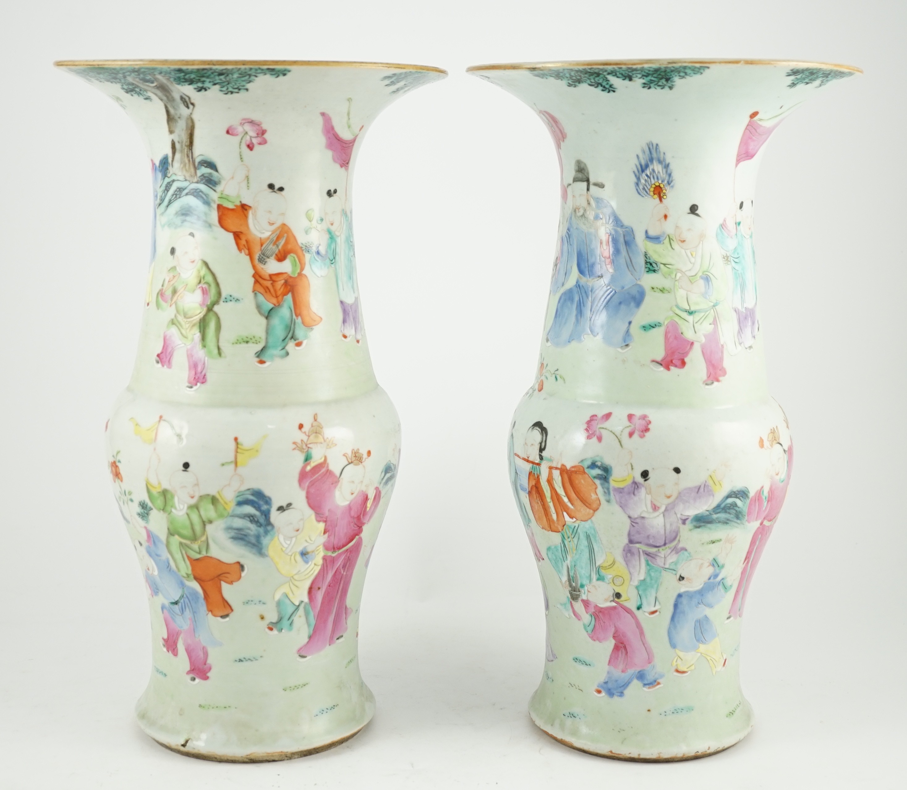 A pair of Chinese famille rose fencai ‘boys’ baluster vases, 19th century, 39.7 and 40cm high, hairline cracks